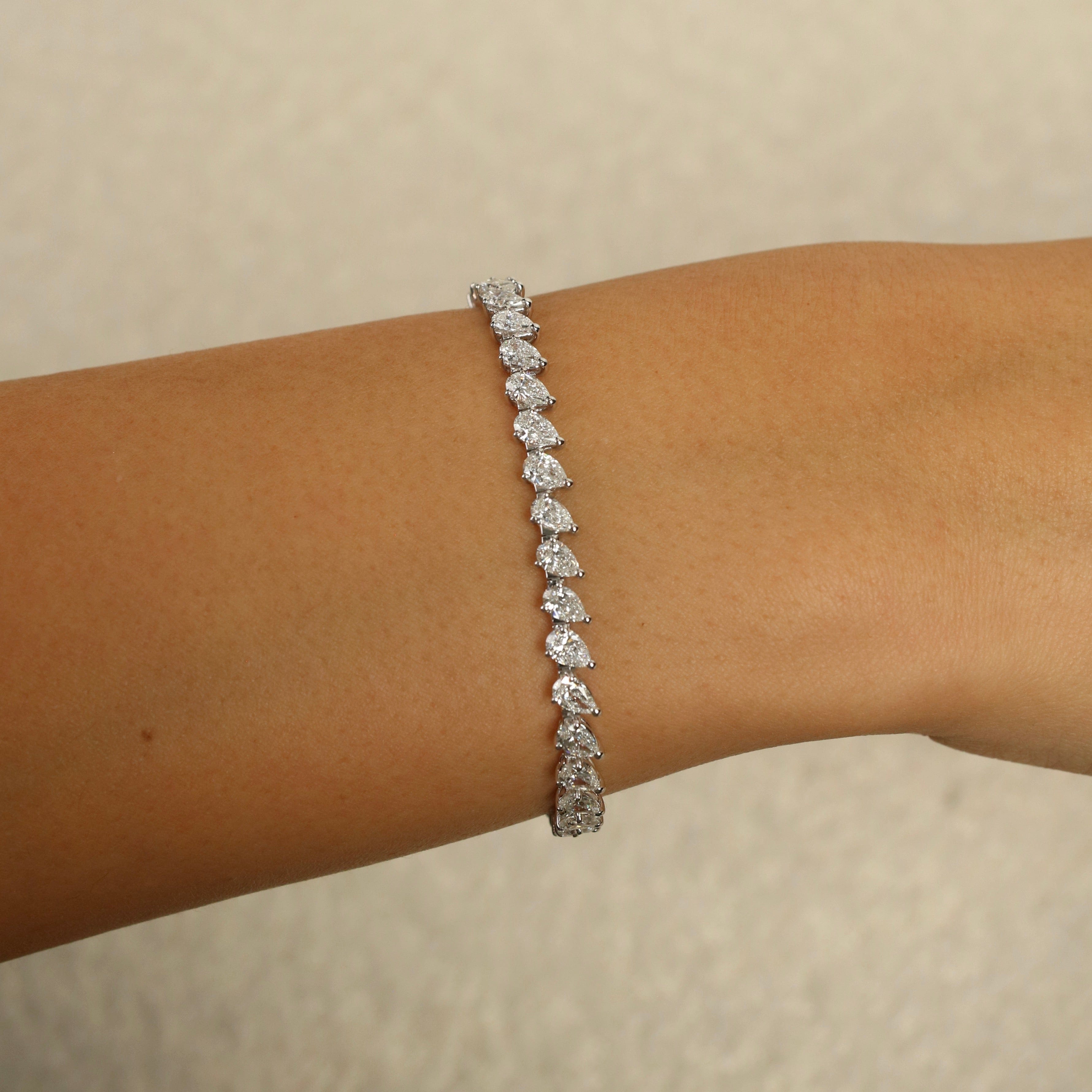 esme-7-carat-pear-shaped-diamond-tennis-bracelet-jewels-aficionado-1208354197.jpg