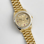 Rolex Day-Date II 218398 Yellow Gold Champagne Ruby Dial Diamond Bezel (2010)