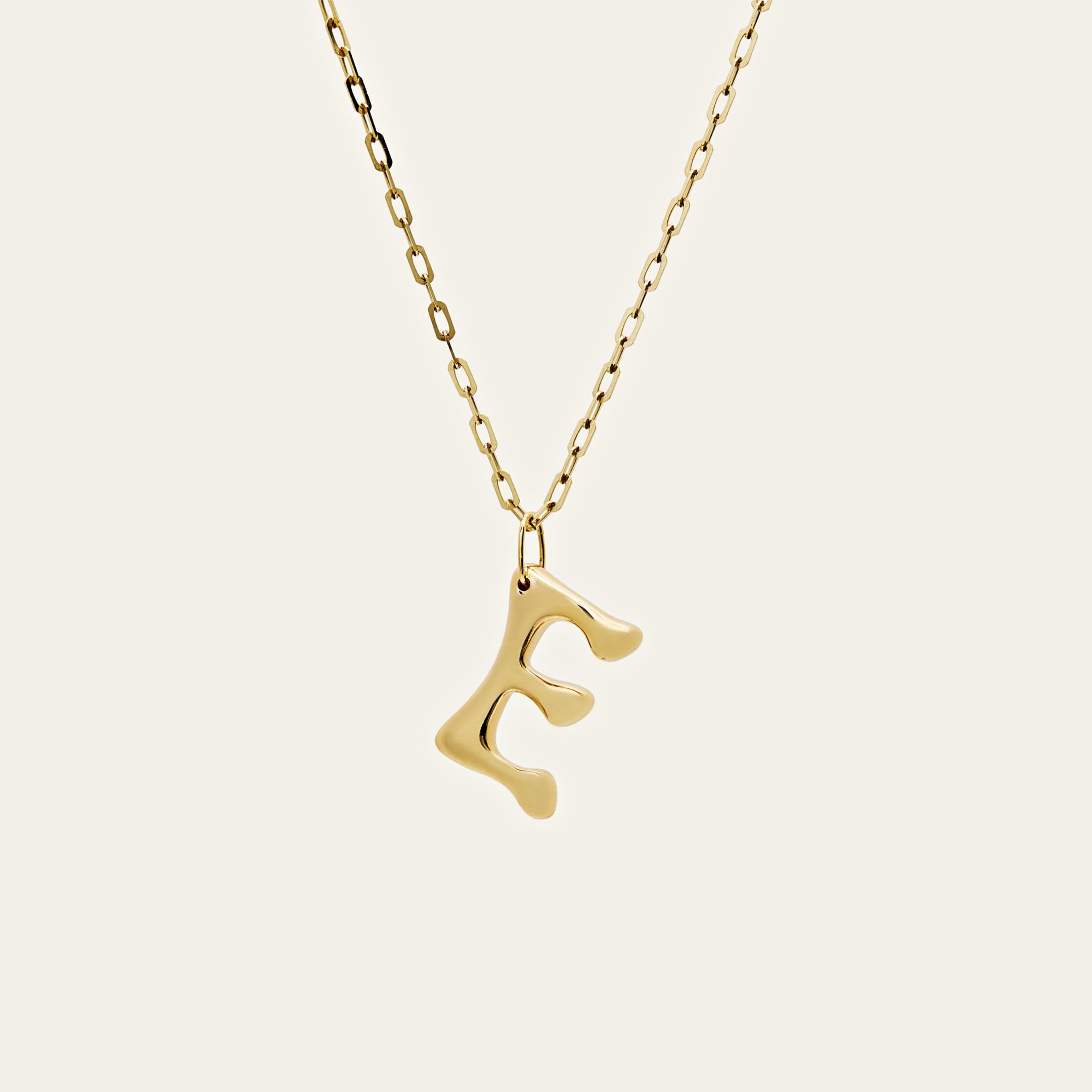 yellow-gold-initial-pendant-jewels-aficionado-1146587520.jpg